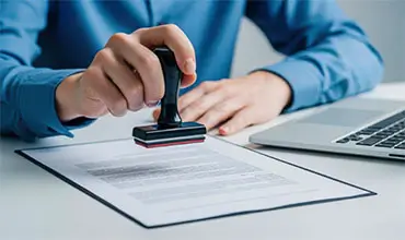 Businessman Sealing Approval with Rubber Stamp on Contract.