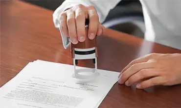 Notary public in office stamping document.